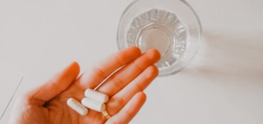 person holding white medication pill