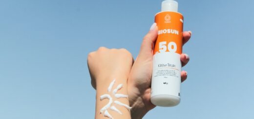 a person holding a bottle of sunscreen in their hand